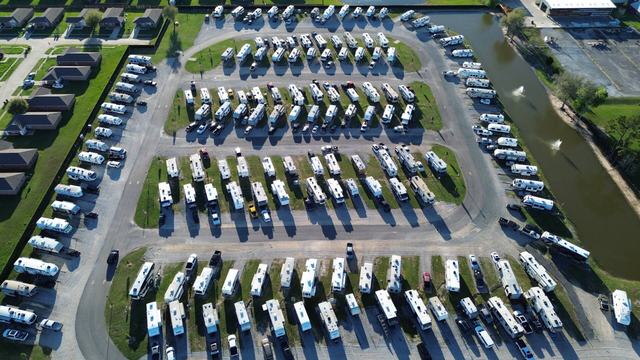 Overhead aerial view of The Gates at McNeese RV Park rows beside a canal with fountains